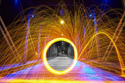 Steel wool orange sparks on wells street bridge in fort wayne, indiana