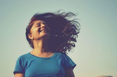 Portrait of a woman against sky