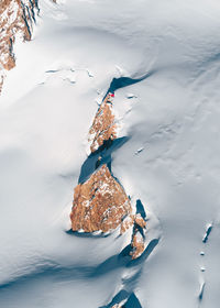 High angle view of ice cream on rock by sea