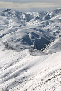 Scenic view of snow covered mountains against sky