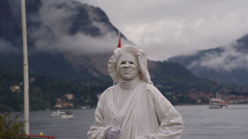 Statue of buddha against cloudy sky