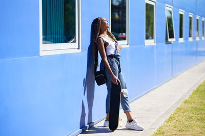 Low section of woman standing against building