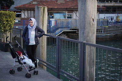 A woman and baby standing on a harbour