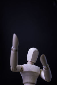 Close-up of figurine against black background