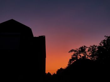 Low angle view of silhouette trees against clear sky