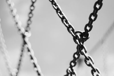 Low angle view of chain against sky