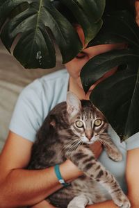 Young girl holding her cat. 