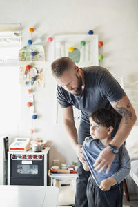 Father and son standing in office