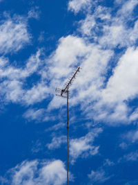 Low angle view of communications tower against sky