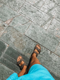 Low section of woman standing on tiled floor