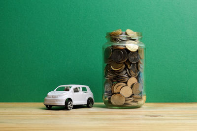 Toy car on table against green background