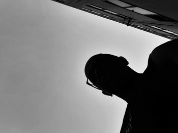 Low angle view of silhouette man against sky