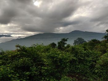 Scenic view of sea and mountains against sky