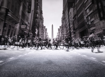 People on city street amidst buildings