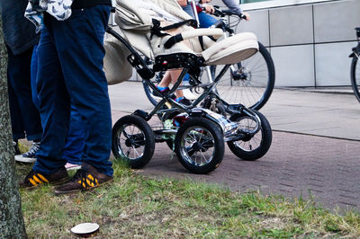 Low section of man riding bicycle on street