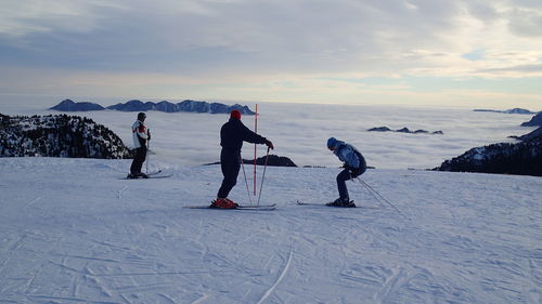 Tourists on snow covered landscape