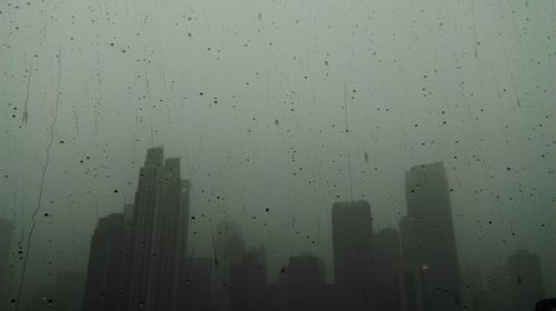 Raindrops on window in city