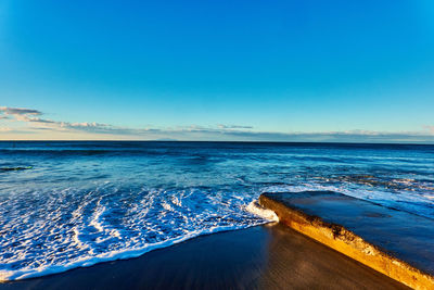 Scenic view of sea against blue sky