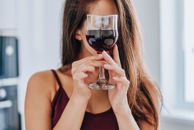 Full length portrait of woman holding glass