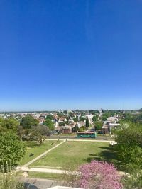 High angle view of buildings against clear blue sky