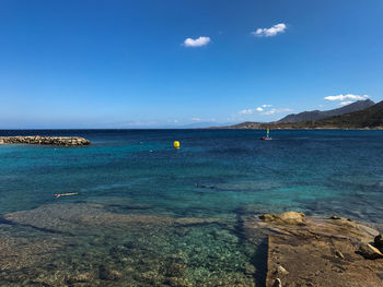 Scenic view of sea against blue sky