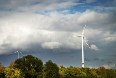 Low angle view of windmill against sky