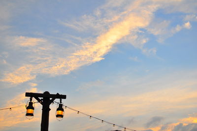 Low angle view of illuminated light against sky during sunset