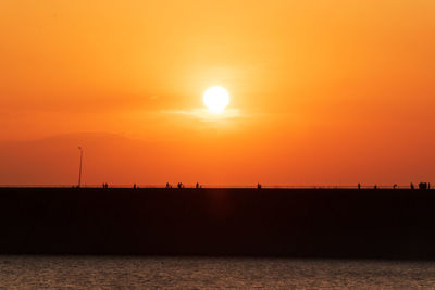 Scenic view of sea against orange sky