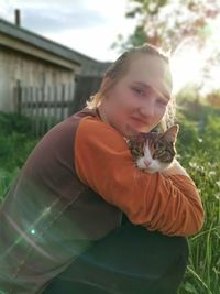 Portrait of woman with cat outdoors