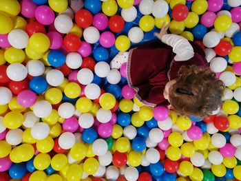 High angle view of woman playing with balloons