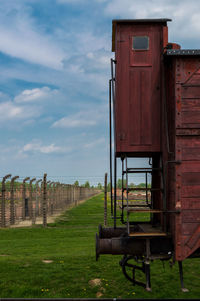 Built structure on field against sky