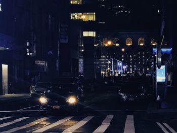 Cars on illuminated road at night