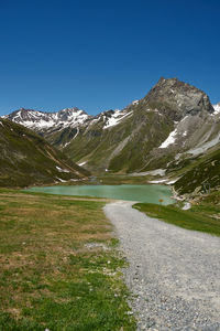 Scenic view of mountains against clear blue sky