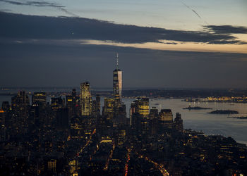 Aerial view of city lit up at sunset