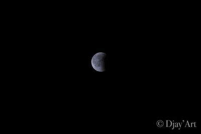 Low angle view of moon against sky at night