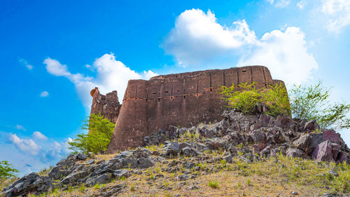 Low angle view of castle against cloudy sky