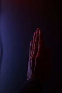 Close-up of human hand against black background