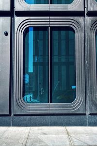 Reflection of train on window of building