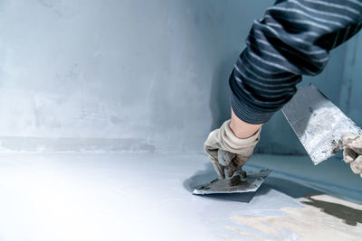 Low section of man skateboarding on floor