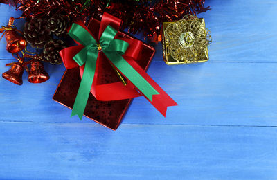 High angle view of multi colored christmas decorations with gifts on floor