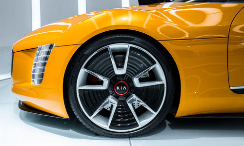 Close-up of yellow car on road