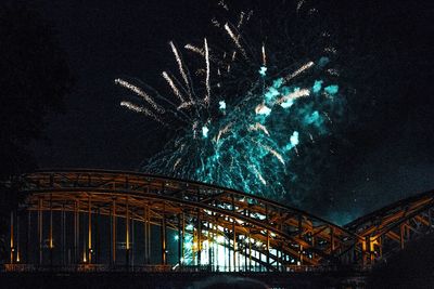 Low angle view of fireworks against sky at night