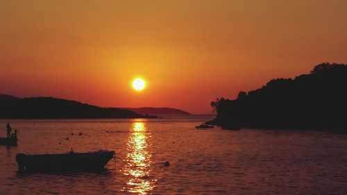 Scenic view of sea against orange sky