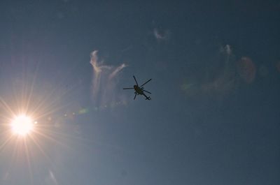 Low angle view of silhouette airplane flying in sky