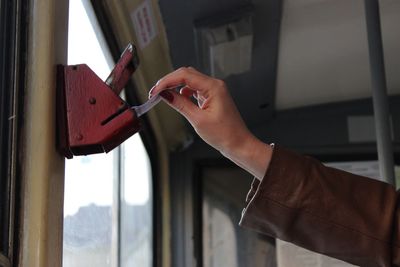 Hand of a woman using old public transportation