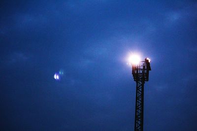 Low angle view of illuminated moon against sky at night