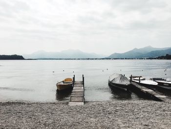 Boats moored on sea against sky