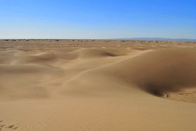 Scenic view of desert against clear sky