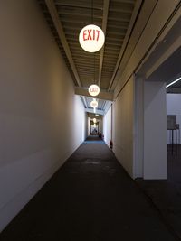 Empty corridor of illuminated building