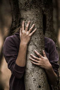 Woman hugging a tree